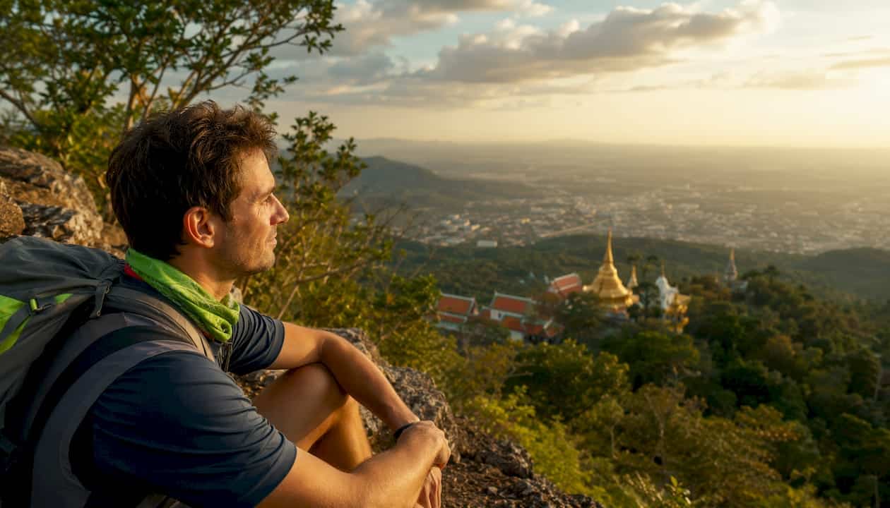 Hiker viewing Chiang Mai temple from trail