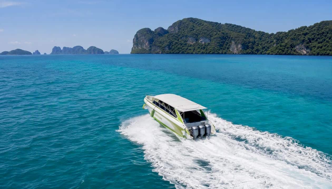 Speedboat creating wake on tropical sea