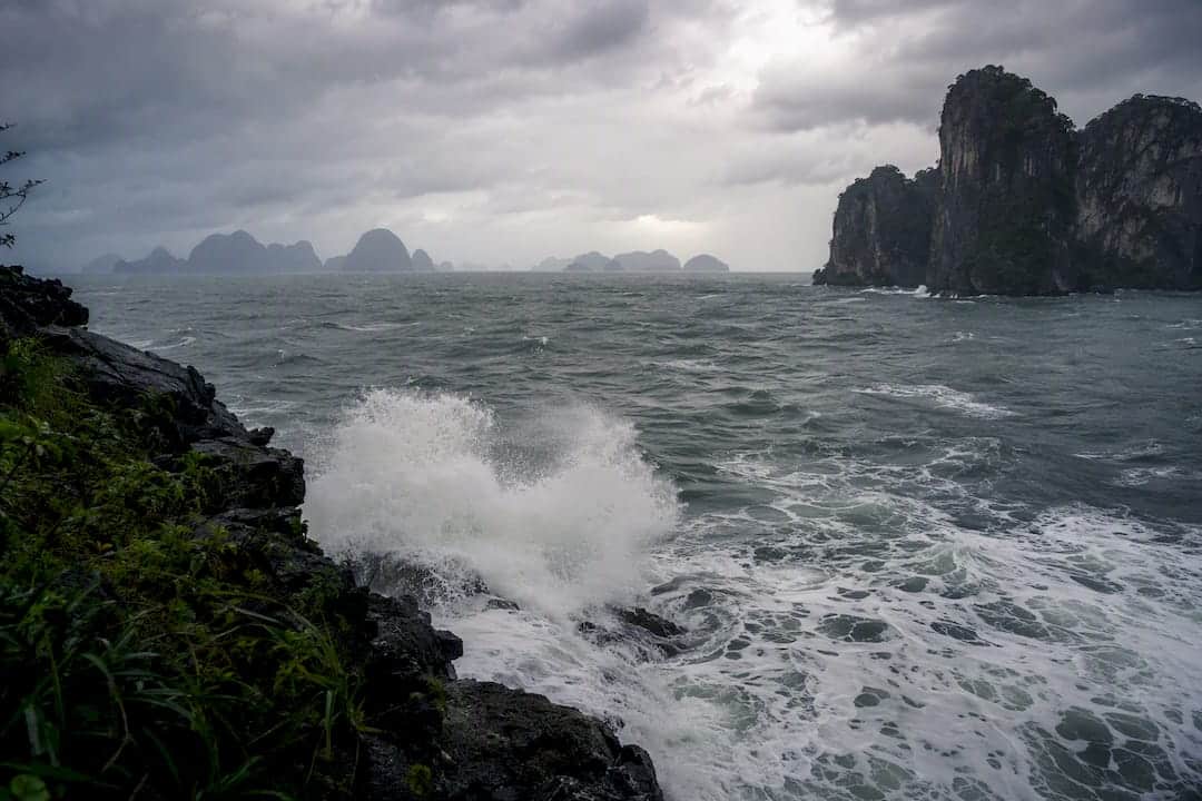 Choppy sea waves and limestone cliffs in overcast weather