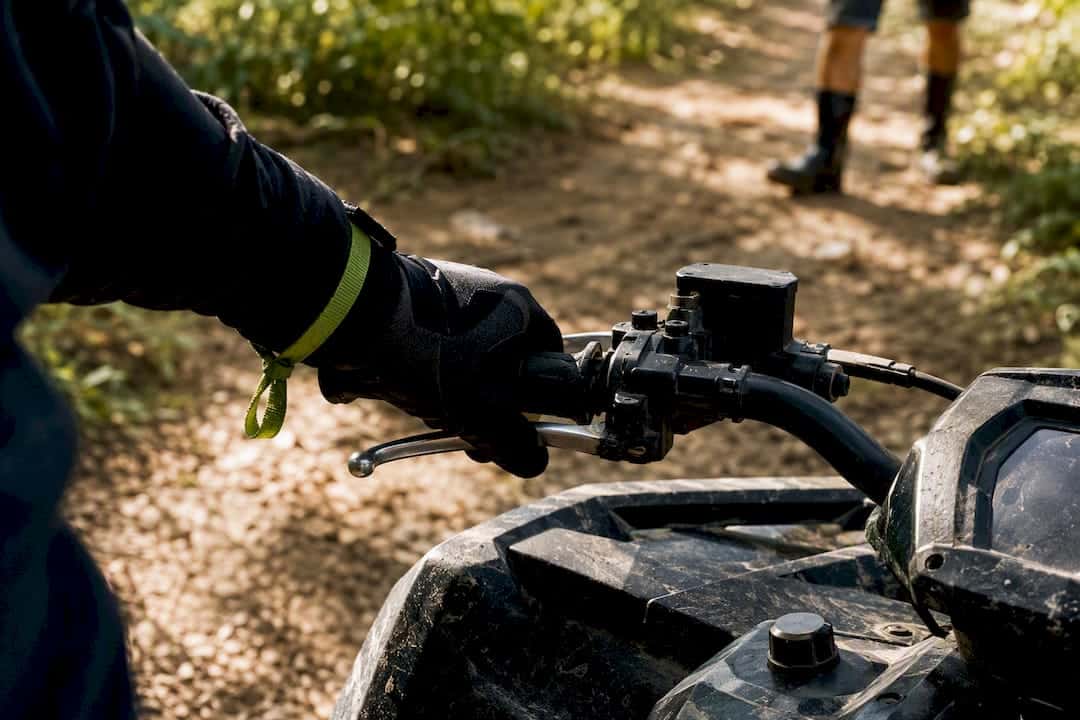 Rider testing ATV brake and throttle