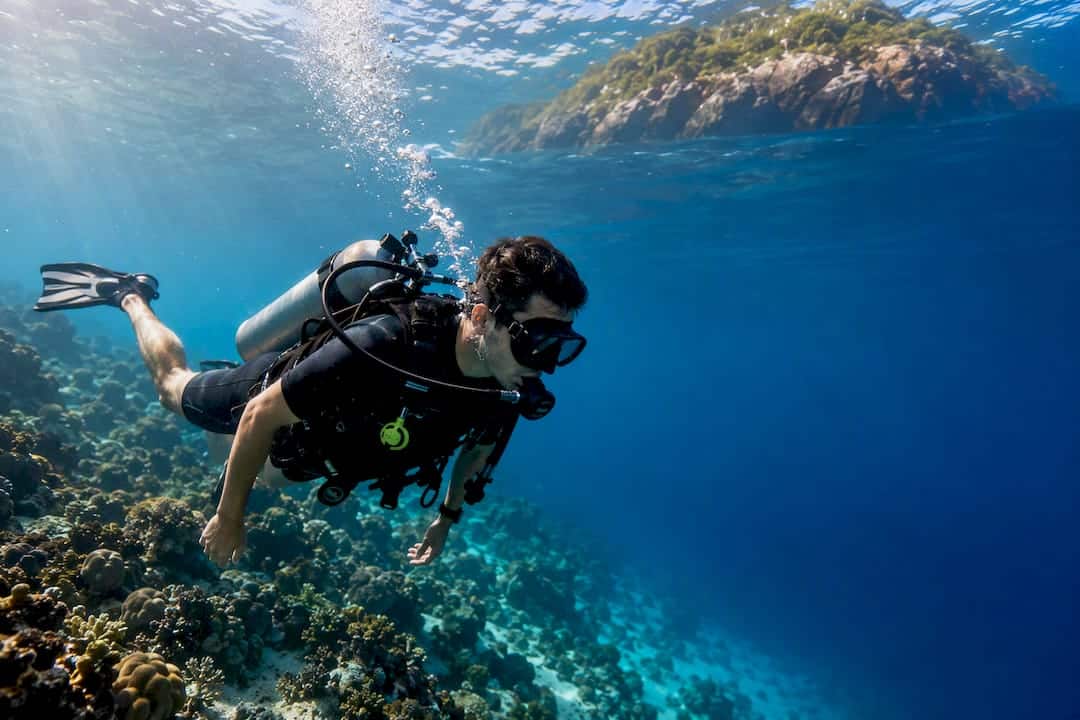 Beginner diver above Racha island coral reef