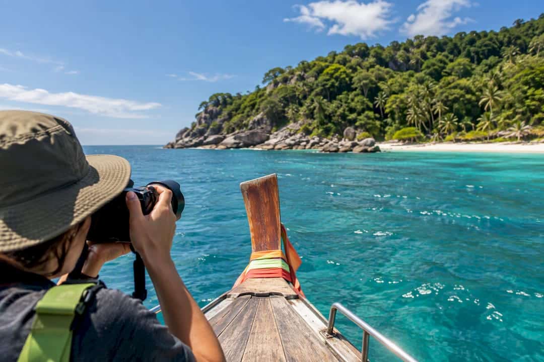 Photographer framing Phuket beach from boat