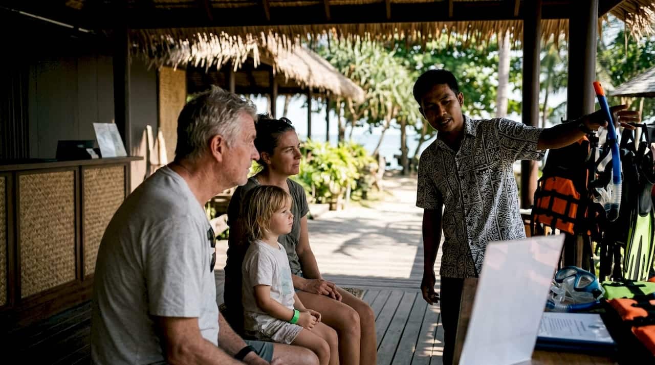 Mixed-age travelers receiving Phuket tour briefing