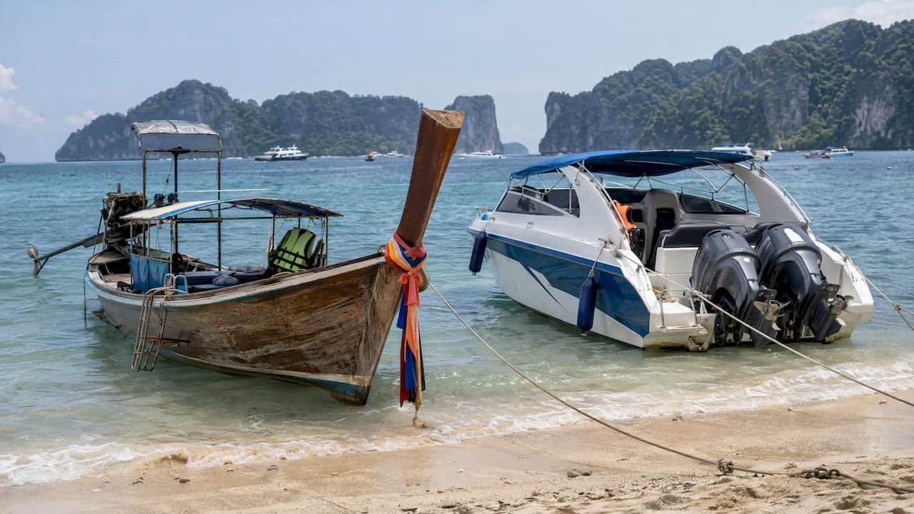 Longtail boat and speedboat moored off Phuket