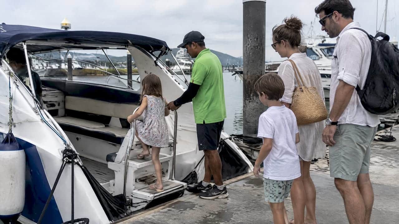 Family boarding a private charter boat in Phuket