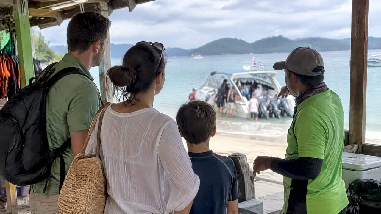 Family discusses Phuket boat tour options with guide