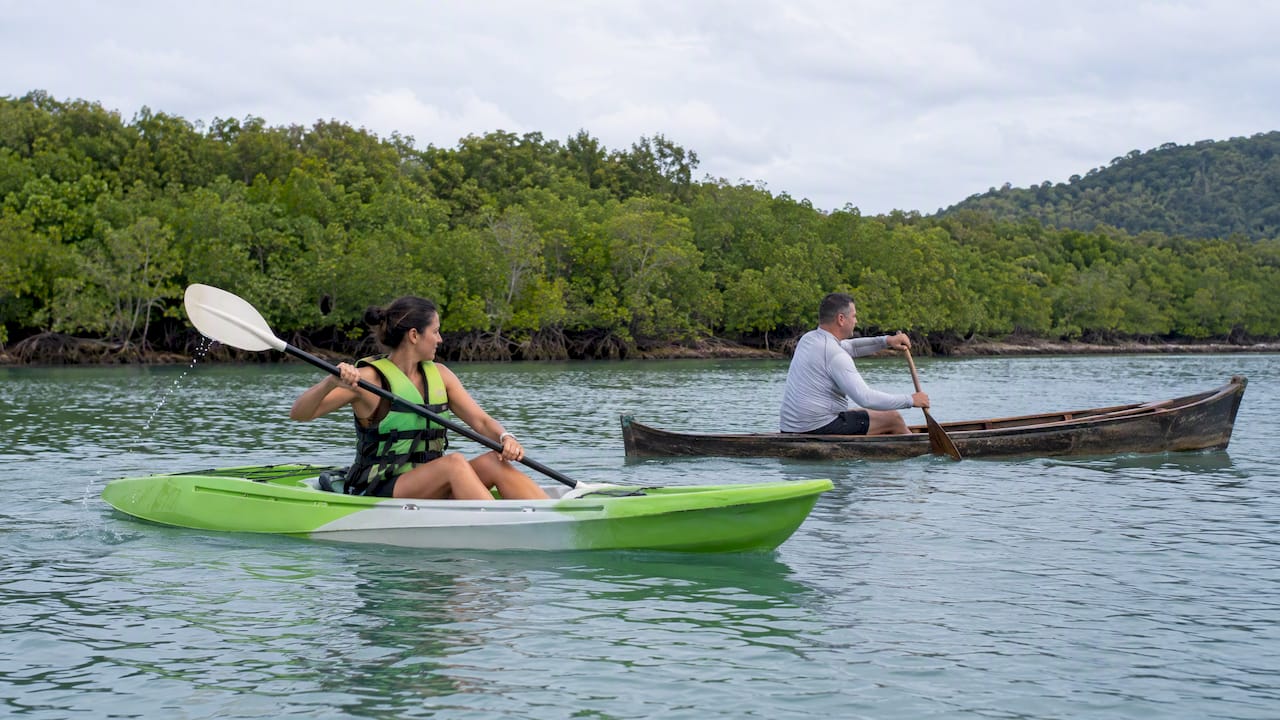 Visitors paddling a kayak and canoe in Phuket