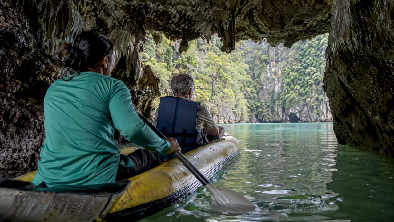 Guided canoe passing through a limestone cave