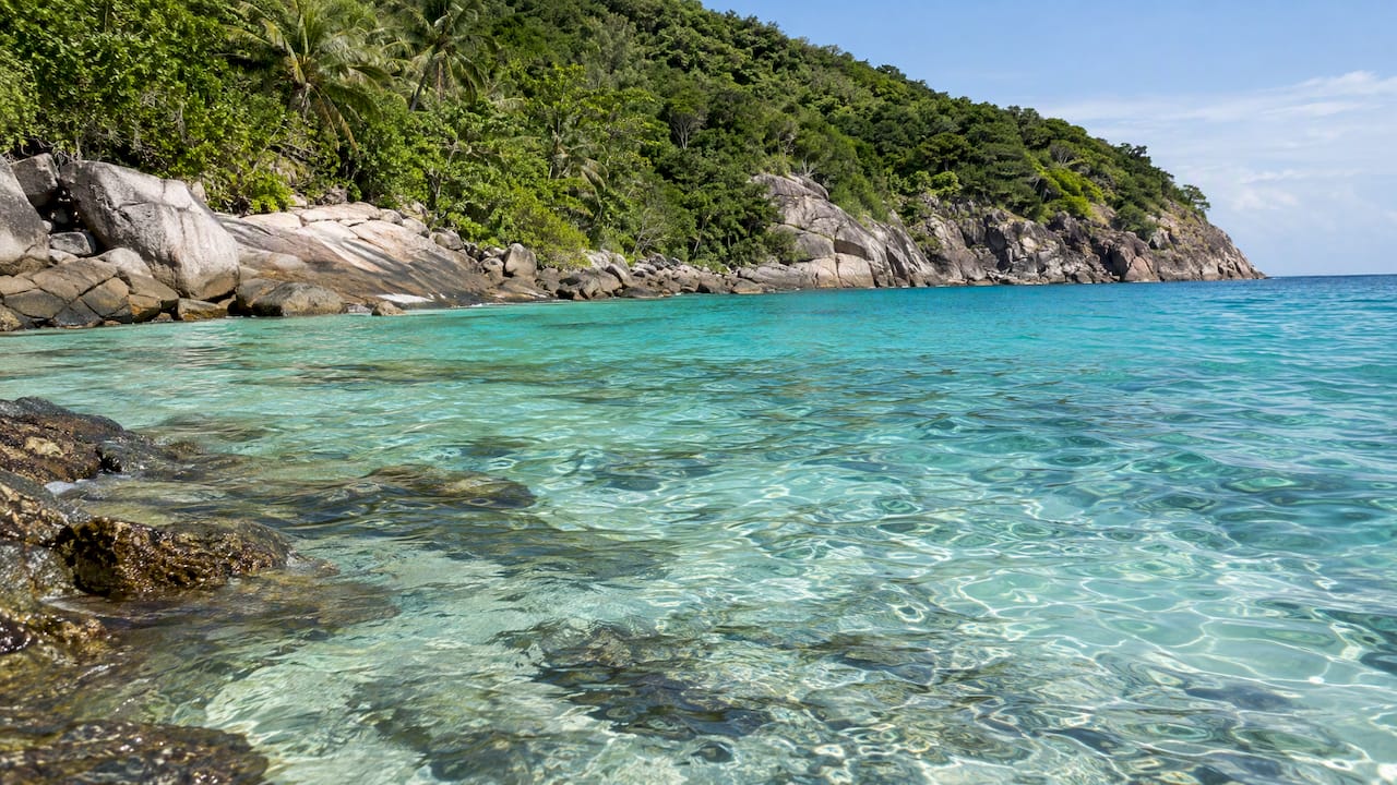 Clear Racha Island water over reef shallows