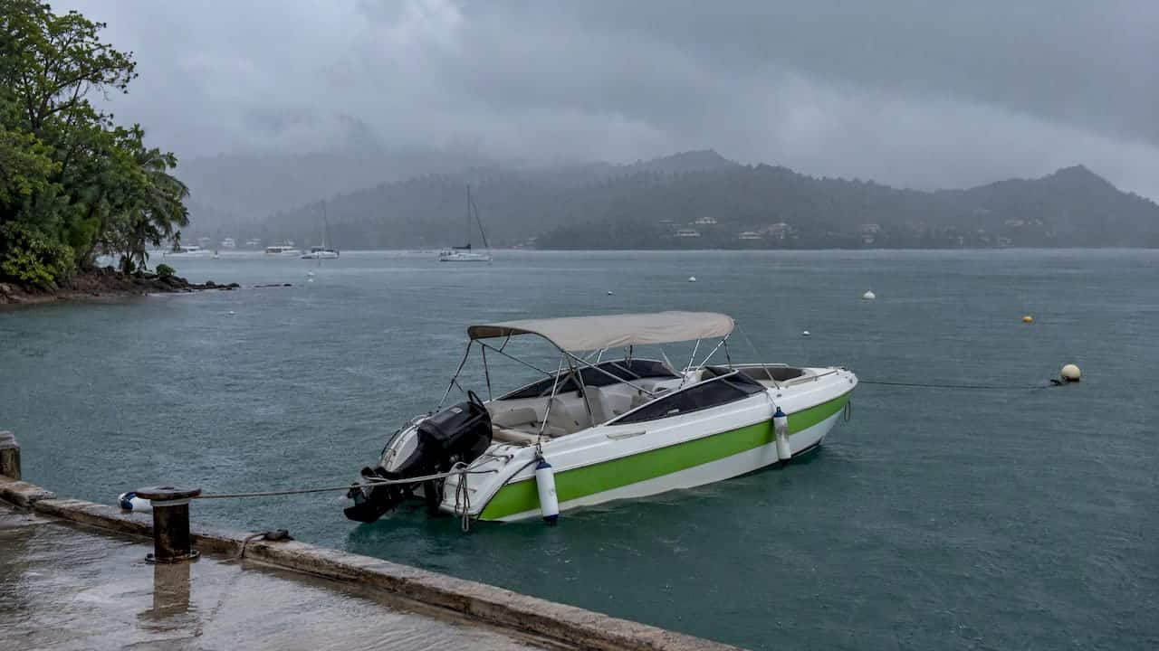 Excursion boat waiting through Phuket monsoon rain