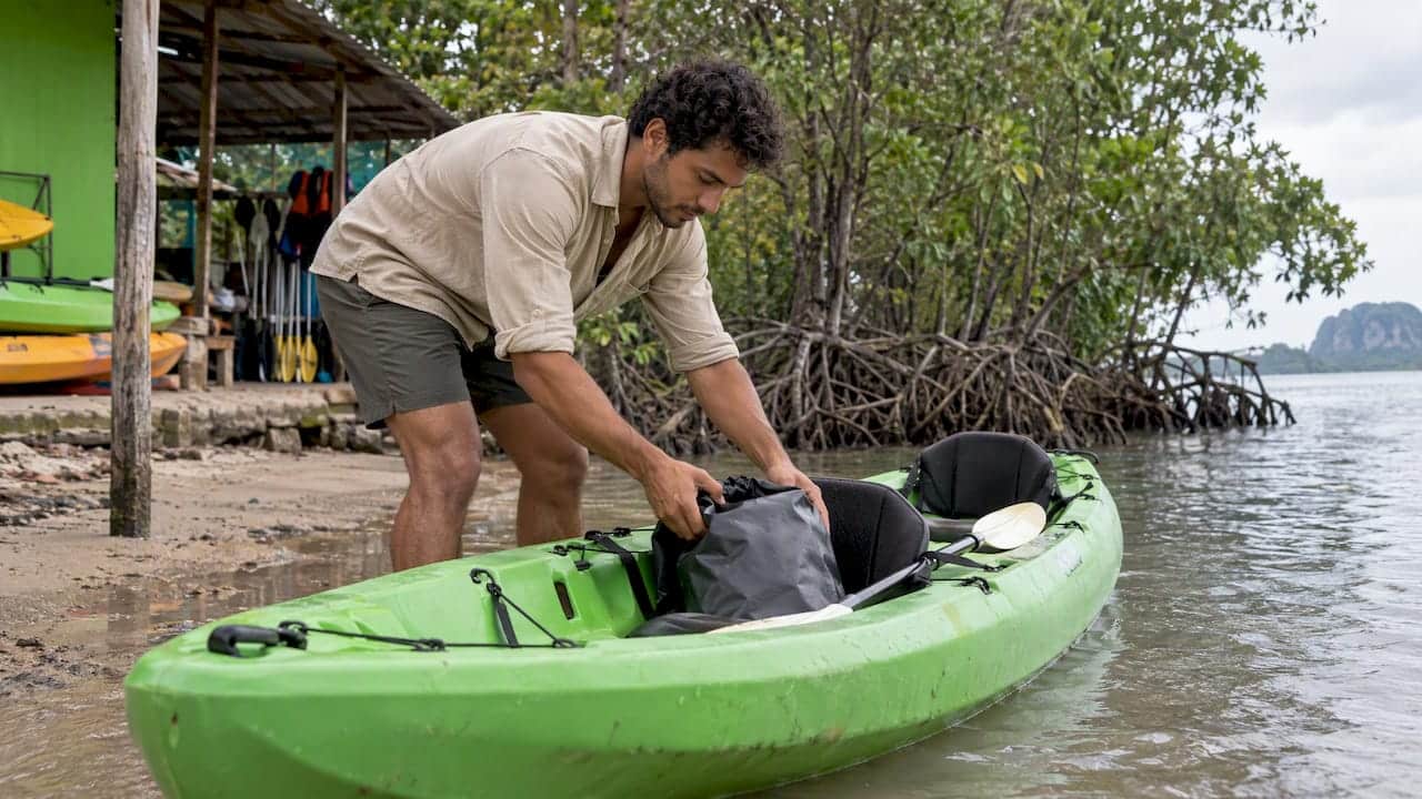 Traveler loading a kayak before paddling