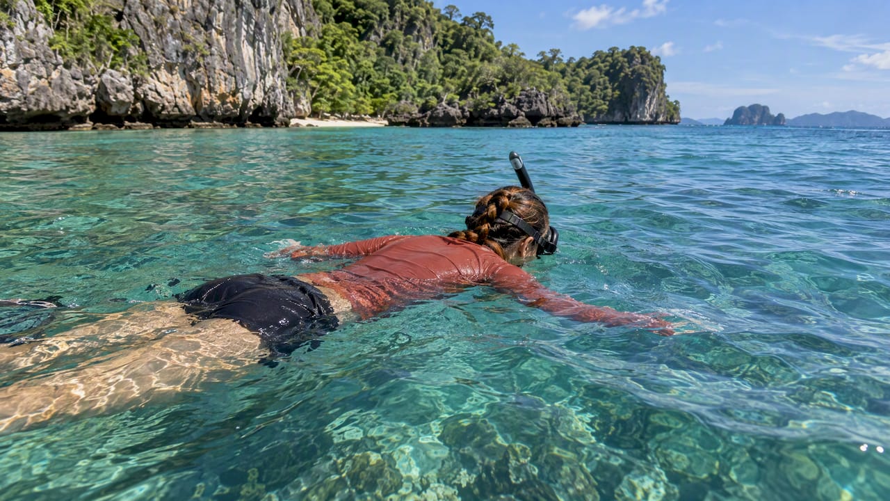 Snorkeller wearing a long-sleeved rash guard
