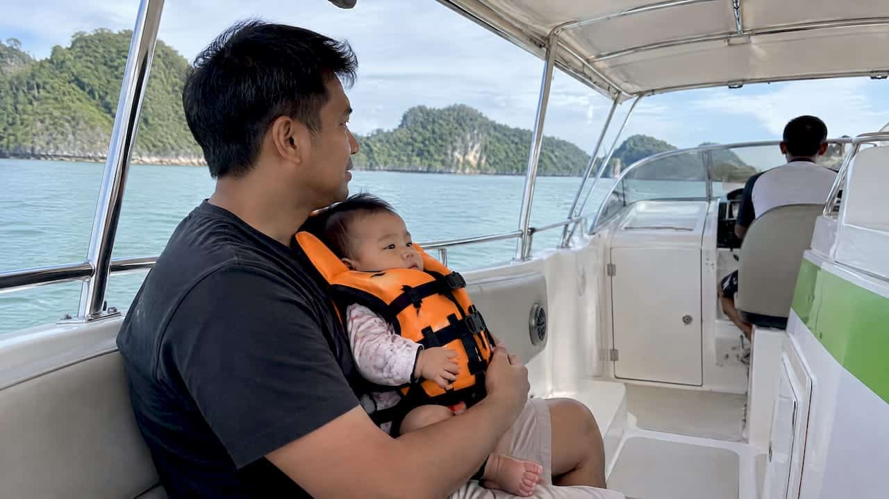 Father holding baby aboard a Phuket boat