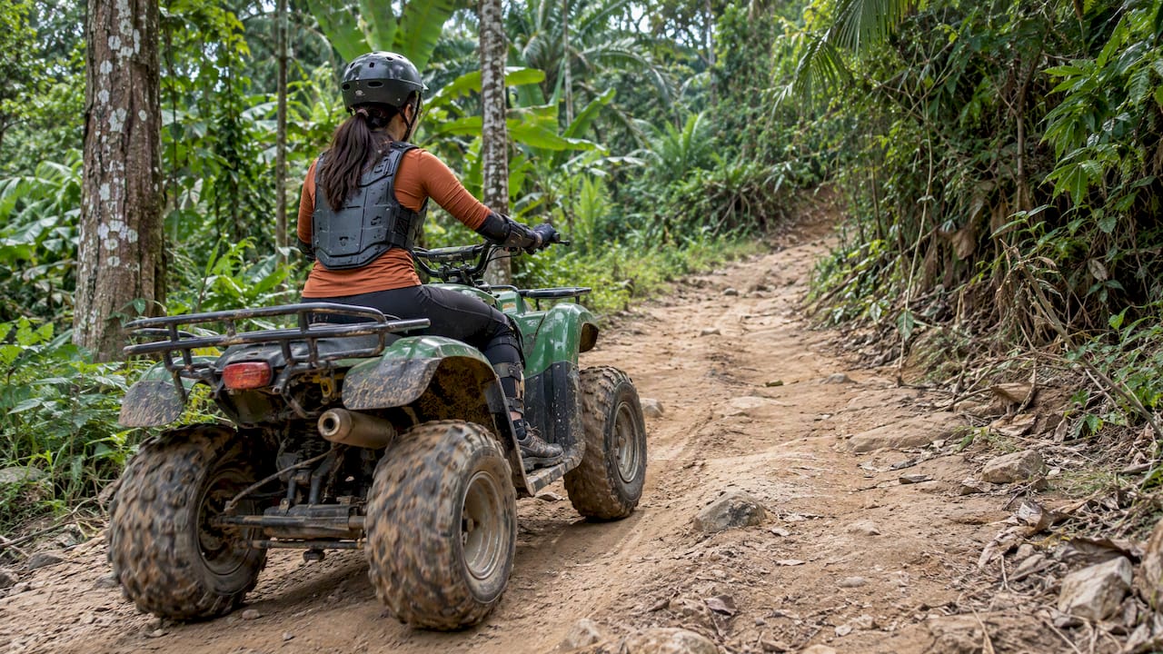 Rider follows a Phuket forest trail